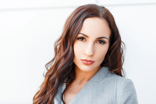 Portrait Of A Young Beautiful Brunette Woman On A White Background