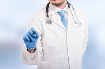 Male doctor writing something with marker
