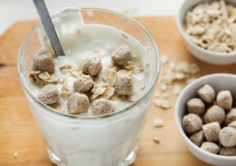 smoothie with wheat bran and oat flakes on a wooden table