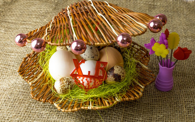 chicken eggs and quail eggs Guinea fowl egg lie together like pearls in a shell on a wooden table