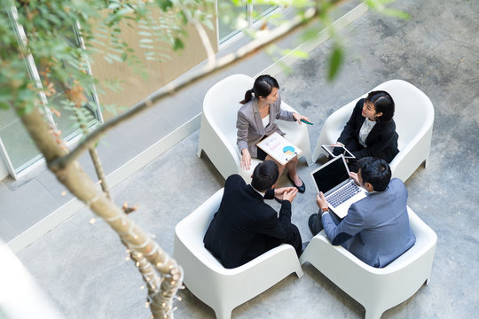 Top view of office with business people meeting together - Powered by Adobe