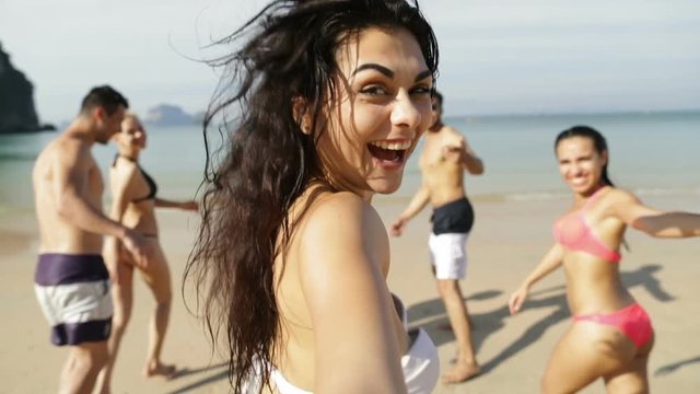 Girl Taking Selfie Of Cheerful People Running In Water On Beach, Happy Young Man And Woman Group Having Fun Slow Motion 120