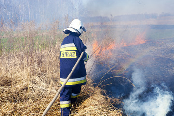Firefighter fights grass fires. Polish firefighter. © Dagmara_K