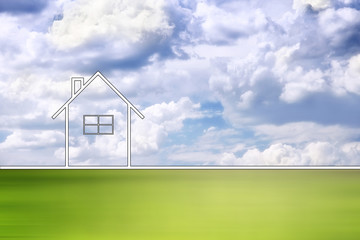 Conceptual eco home healthy living copy space background with motion blurred green meadow and cloudy sky.