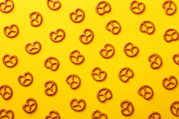 Flat lay pretzels pattern on yellow background