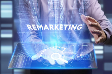 Fototapeta na wymiar Business, Technology, Internet and network concept. Young businessman working on a virtual screen of the future and sees the inscription: Remarketing