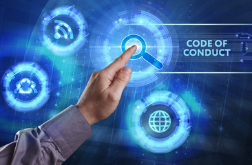 Fototapeta premium Business, Technology, Internet and network concept. Young businessman working on a virtual screen of the future and sees the inscription: Code of conduct