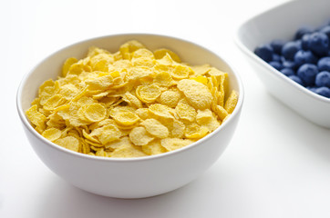 Bowl of cornflakes on white background