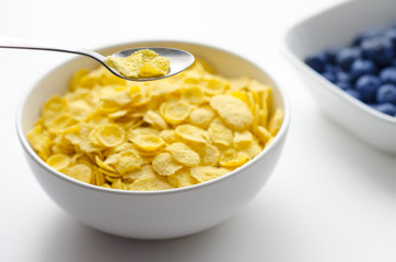 Bowl of cornflakes on white background