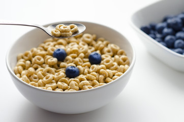 Bowl of cereal rings on white background close up