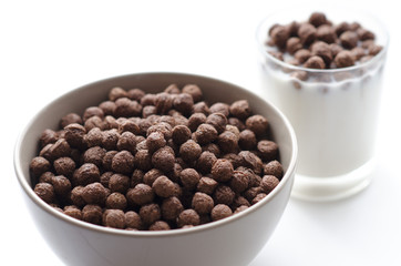 Bowl of cocoa cereals on white background close up