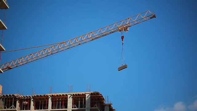 Video construction crane transports cargo on a Building site
