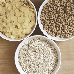 Bowls of cereal on a wooden table top view, vintage filter