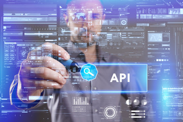 Fototapeta premium Business, Technology, Internet and network concept. Young businessman working on a virtual screen of the future and sees the inscription: API
