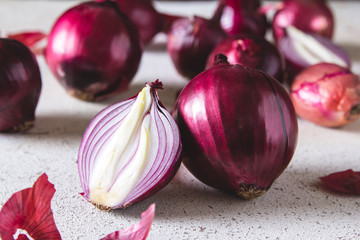 Red onion bulbs on white painted table