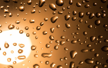 Water drops on the glass at sunset