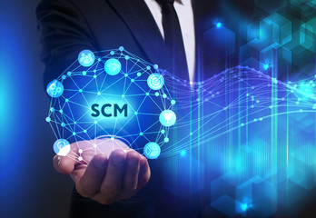 Business, Technology, Internet and network concept. Young businessman working on a virtual screen of the future and sees the inscription: SCM