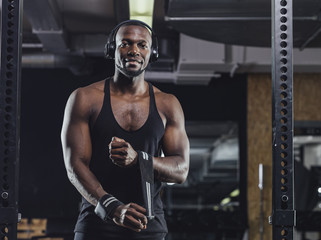 Fototapeta na wymiar Athlete standing in gym, preparing for training