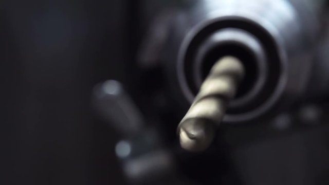 Close-up View of Spinning Metal Spiral Drill Bit. 4K