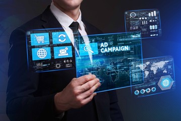 Business, Technology, Internet and network concept. Young businessman working on a virtual screen of the future and sees the inscription: Ad campaign