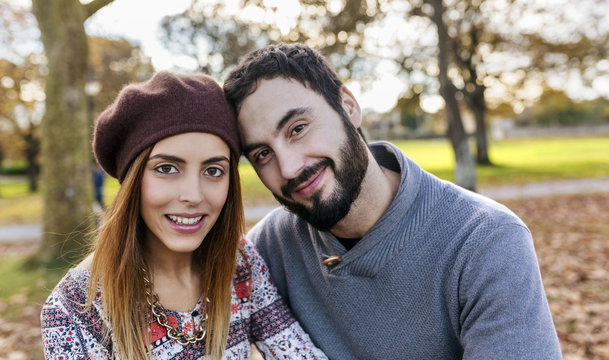 Portrait of happy couple in autumnal park