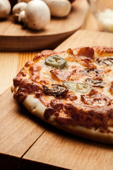 Slices of pizza with bacon, olives and jalapeno papper
