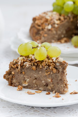 piece of nut pie with grapes, vertical