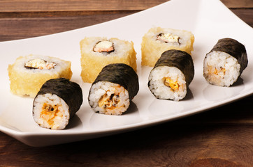 Sushi rolls on a white plate