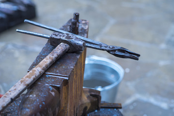 A metal fabricator utilizing a torch to heat up a piece of metal in order to shape it utilizing a forging technique developed over hundred years ago.