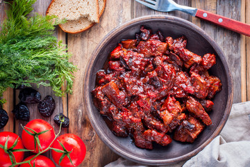 Beef with tomatoes and prunes, top view, horizontal