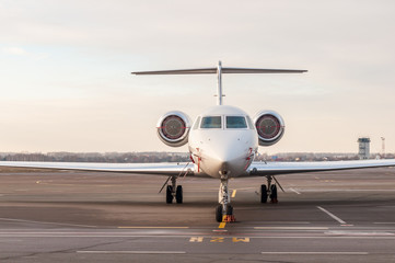 Luxury business jet stands at the airport and ready for boarding. Private aircraft front view