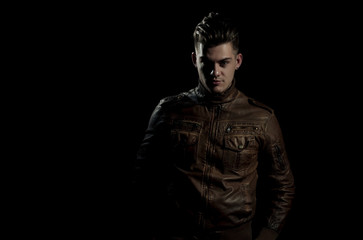 Fototapeta na wymiar Handsome man posing in brown, leather jacket