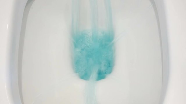 flushing toilet blue water