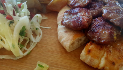 Meatballs grill and salad on wooden service