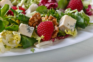 Green salad with blue cheese , raspberry and nuts