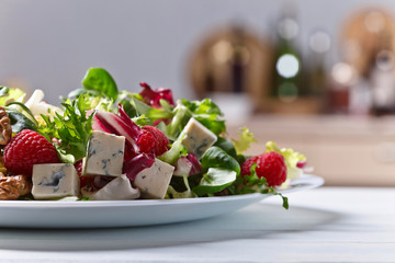 Green salad with blue cheese , raspberry and nuts