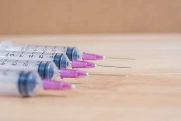 Syringe On Wood Background
