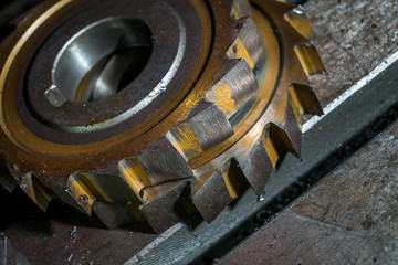 Obraz na płótnie Canvas metal working. Process of tooth gear wheel finish machining by cutter tool at factory