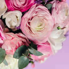 Delicate wedding bouquet of ranunculus flower, freesia and eucalyptus leaves. Close up. Floral background