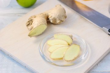Ginger root slices on transparent glass plate.