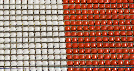 Empty red and white seats in a stadium