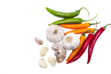 Garlics, garlic cloves and colorful chili top view on white background