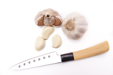Garlic, garlic cloves and knife top view on white background