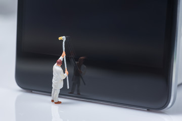 miniature people worker cleaning smart phone screen