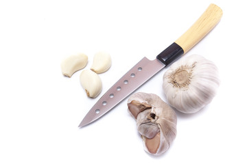 Garlic, garlic cloves and knife on white background