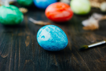 Blue easter egg like planet Earth on brown wooden table.