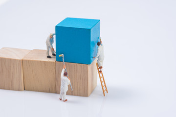 miniature people worker painting wood cube building block
