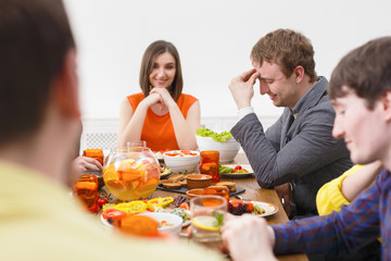 Group of happy people at festive table dinner party