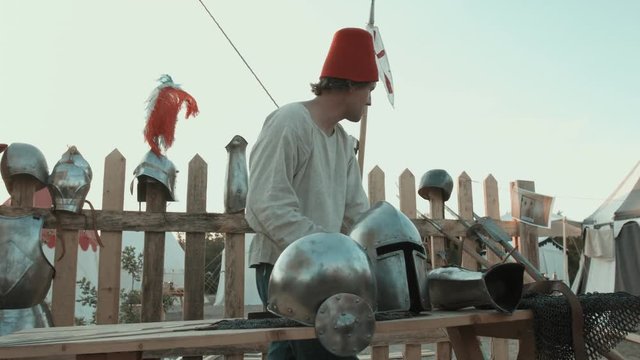 Medieval master rubbing iron armor, helmets and swords