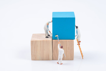 miniature people worker painting wood cube building block